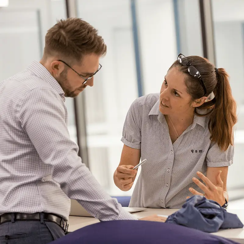 Physiotherapist Marguerite King speaking to another clinician at the QSMC clinic in Bowen Hills