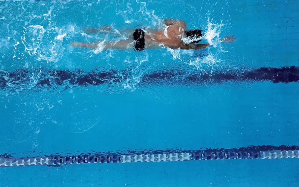 Image of a swimmer doing freestyle through a pool