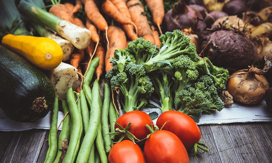 A table with fresh vegetables on top