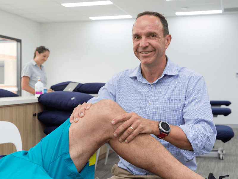 A photo of Physiotherapist Rob Godbolt treating a QSMC patient's knee
