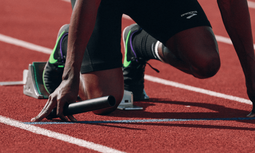 Track athlete in the starting blocks about to start a relay race
